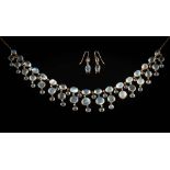 A moonstone fringe necklace: with round and oval moonstones in spectacle frame settings,