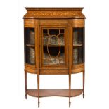 An Edwardian mahogany and inlaid display cabinet:, of D-shaped breakfront outline,