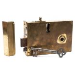 A Georgian brass door lock, of large size: of rectangular outline with cast steel key,