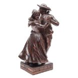 A French carved wood group of a dancing couple: in traditional costume, mounted on a square base,