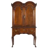 An early 18th Century oak double domed cabinet on an associated later 18th Century stand:,