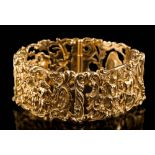 A 14ct gold panel-link bracelet: the links cast with openwork scenes of figures in Rococo-style
