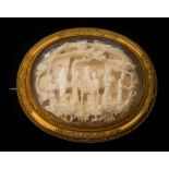 A late 19th century Cantonese carved ivory and gold oval glazed brooch: depicting figures on a