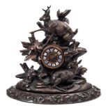A Black Forest carved walnut mantel clock: the French eight-day duration movement striking the