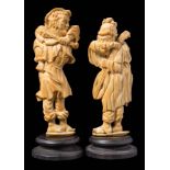 A pair of late 19th century Dieppe carved ivory figures: semi-ronde peasant musicians,