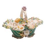 A large Coalport flower encrusted basket: with green ground exterior,