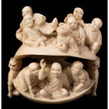 A large Japanese carved ivory netsuke of a clam: with monks in the interior and exterior,