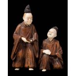 A Japanese boxwood and ivory okimono of entertainers,