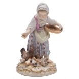 A Meissen porcelain figure: modelled after the original by Kaendler as a young girl feeding