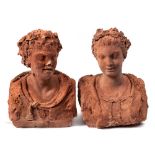 Two terracotta busts of a young woman and man: the man wearing a lion skin cloak,