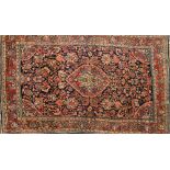 A Meshed rug:, the indigo field with a central red hexagonal pole medallion,