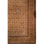 A Sivas carpet:, the beige field with an all over geometric palmette, medallion and leaf design,