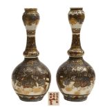 A pair of Japanese Satsuma gourd shaped bottle vases: each painted and gilded with panels of