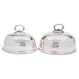 Two early 20th century silver plated graduated dish covers: of domed outline with loop carrying
