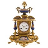 A gilt-metal and porcelain mantel clock: the eight-day duration movement striking the hours and