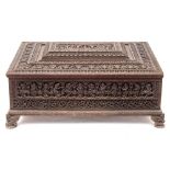 A 19th century Indian carved hardwood casket of large size: of rectangular outline,