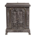 A cast iron stove:, with pierced foliate scroll and lattice panels,