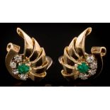 A pair of emerald and diamond fan-shaped ear clips: each with a circular emerald surrounded by four