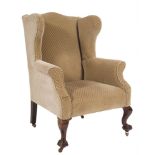 A carved mahogany wing frame armchair in the Georgian taste:, fully upholstered, on cabriole legs,