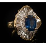 A sapphire and diamond ballerina cluster ring: centring an oval sapphire approximately 11mm long x