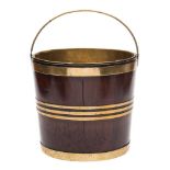 An 18th century mahogany and brass bound bucket: with brass loop carrying handle and brass liner,
