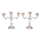 A pair of Elizabeth II silver twin-branch candelabra, maker W I Broadway & Co.