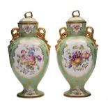 A pair of Copeland Spode vases and covers: of footed oviform with gilt ribbon handles and knops