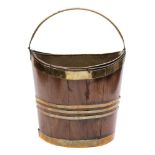 An 18th century mahogany and brass bound navette shaped bucket: of coopered construction,