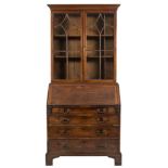 A George III mahogany bureau bookcase:, of small size, the upper part with a moulded cornice,