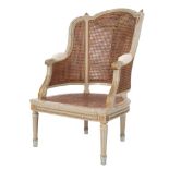 A French carved wood and grey and gilt decorated Bergere armchair:,