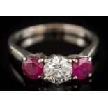 A ruby and diamond three-stone ring: with central round, brilliant-cut diamond approximately 5.