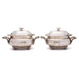 A pair of Sheffield plate tureens and covers: of oval outline with domed lift-off lids,