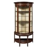 A carved mahogany demi-lune upright display cabinet:,