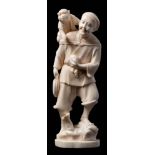 A Japanese carved ivory okimono: in the form of a standing smiling man,
