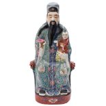 A Chinese famille rose figure of Shou Lao: the seated Immortal wearing elaborate blue and turquoise