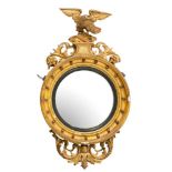 A Regency carved giltwood and gesso circular convex mirror:,