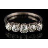 A graduated diamond five-stone ring: the round old brilliant-cut diamonds estimated to weigh a