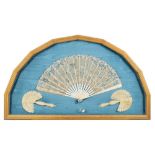 A 19th century English ivory fan: with painted silk and applied lace leaf decorated with a painted