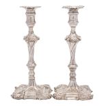 A matched pair of silver cast candlesticks, maker William Cafe, London, 1759 and 1765.