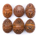 A collection of six carved egg-shaped coquilla nut pomanders: with concentric ringed,