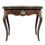 A 19th Century French ebonised and gilt metal mounted card table:, of serpentine outline,