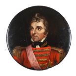 A 19th century papier mache snuff box: the circular lid decorated with a portrait of the Duke of