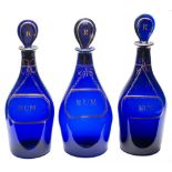A group of seven Bristol blue glass decanters and stoppers: each of mallet shaped form with lozenge