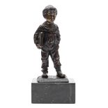 A bronze figure of a Dutch boy with satchel: indistinctly signed O.