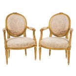A set of four carved giltwood fauteuils:, in the Louis XV/XVI transitional taste,