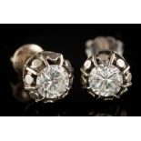 A pair of diamond single-stone ear studs: each with a circular,