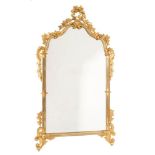 A pair of carved giltwood wall mirrors:, of shaped arched outline with flowerhead,