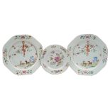 A pair of Chinese famille rose plates and one other: the pair painted with a stag and doe,