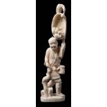 A Japanese carved ivory okimono: of a cormorant fisherman holding a large net of fish above his