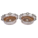 A pair of Victorian silver plated coasters: of circular outline with scroll and foliate decorated